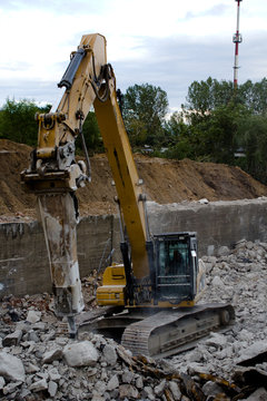 close up of excavator bucket isolated , sunny evening sky in the background, picture taken on a building site during demolishing work 