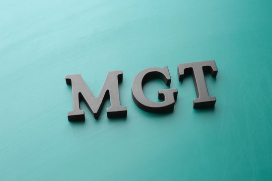 Management abbreviation MGT made with letters on color background
