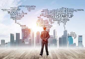 Motivation and inspiration concept with modern cityscape and businessman observing it