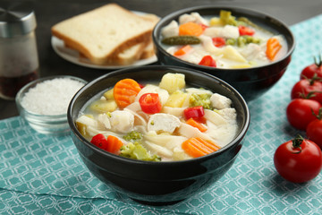 Bowl with delicious turkey soup on table