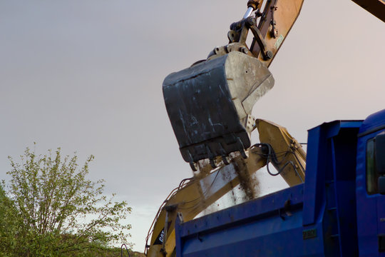 close up of excavator bucket isolated , sunny evening sky in the background, picture taken on a building site during demolishing work 