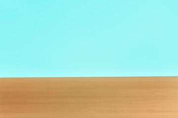 Wooden table against mint background