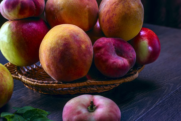 Still life of peaches and juice on a dark background