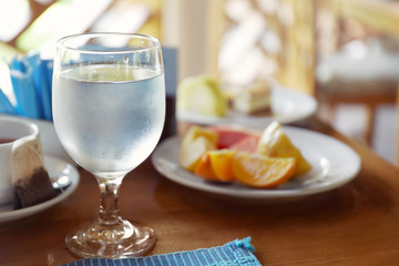 Glass with cold water on table in cafe