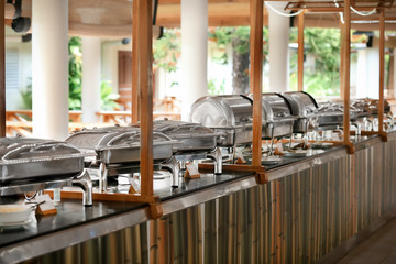 Chafing dishes with food in modern cafe