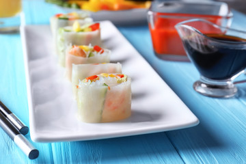 Fresh sliced vegetable Vietnamese spring rolls with shrimps on table