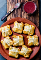 Mini chilean empanadas on clay plate with typical chilean drink vino con harina - red wine with toasted flour