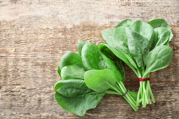 Fresh spinach bunches on wooden background © Africa Studio