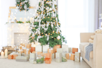 Blurred view of beautiful fir tree in decorated for Christmas room