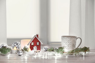 Cup of tea and trendy Christmas interior decorations on table