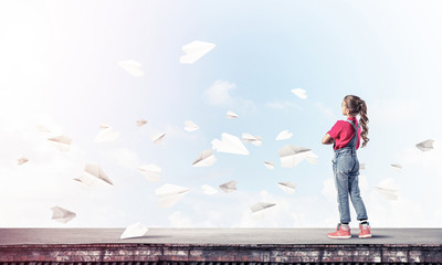 Concept of careless happy childhood with girl looking far away