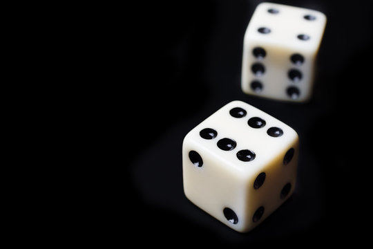 Dice on a black background - selective focus