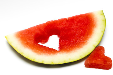 Fresh slice of watermelon with heart isolated on white background