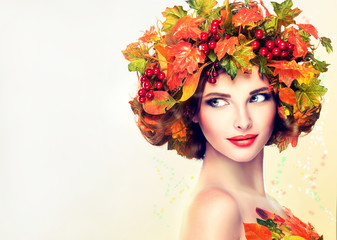 Autumn Beauty - woman fashion Makeup With Red and yellow autumn Leaves. Autumn wreath on girl head . Emotions and surprise on the face of the autumn girl 