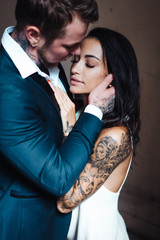 Beautiful, young couple posing on camera indoors
