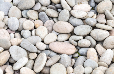 Fototapeta na wymiar Stone background of whitewashed cobblestones close-up of the beach of the sea