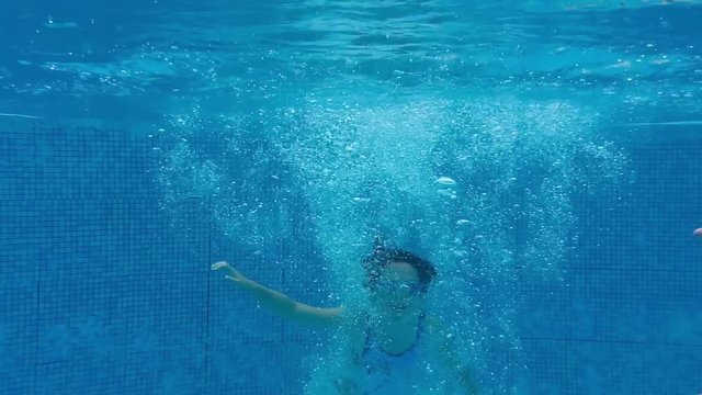 Young girl underwater with lots of bubbles in slow motion