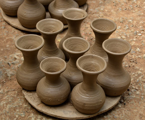 Fototapeta na wymiar Handmade terracotta pots. Clay pots before painting. Craftsmanship.
