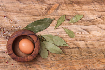 Raw egg on wooden background, top view.