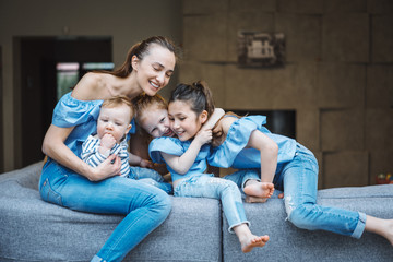 Mom, two daughters and a little son on the couch