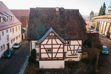 View from a high point to a beautiful street with a traditional German house in Rothenburg ob der...