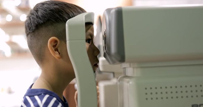 Young little boy undergo eye test