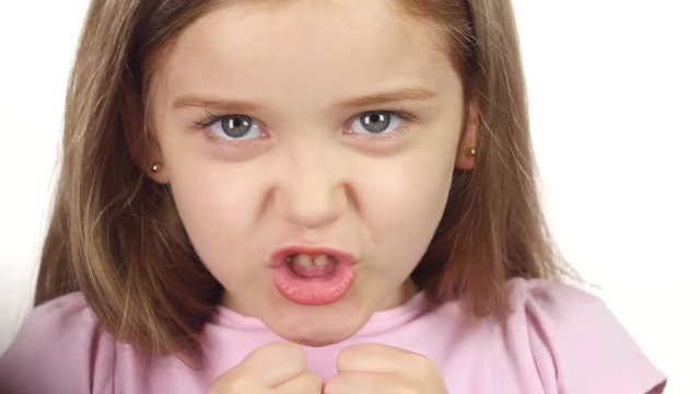 Child is angry, she is very nervous. . White background. Close up