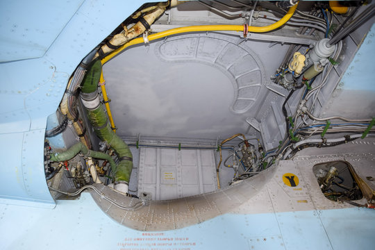 An open compartment for equipment in the fighter. Su-35 fighter. Aircraft on the airfield to show the audience.