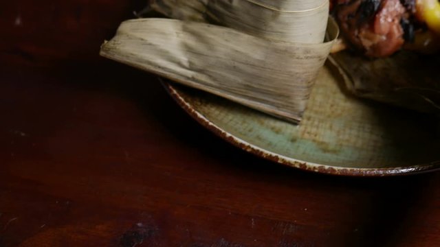 'Zongzi' or 'bakcang', 'bacang' a Chinese traditional food made of glutinous rice  with different fillings and wrapped in bamboo or large leaves.