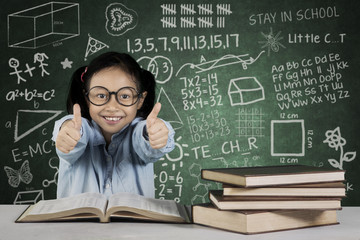 Girl showing ok sign with books and scribble