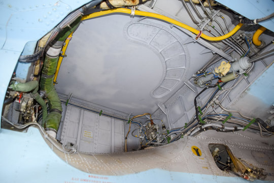 An open compartment for equipment in the fighter. Su-35 fighter. Aircraft on the airfield to show the audience.