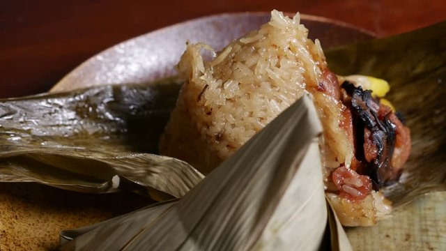 'Zongzi' or 'bakcang', 'bacang' a Chinese traditional food made of glutinous rice  with different fillings and wrapped in bamboo or large leaves.