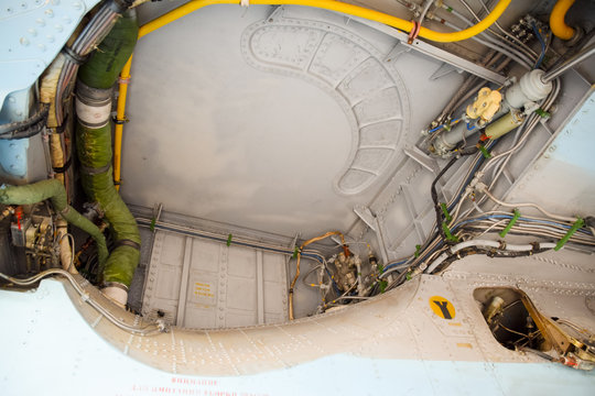 An open compartment for equipment in the fighter. Su-35 fighter. Aircraft on the airfield to show the audience.