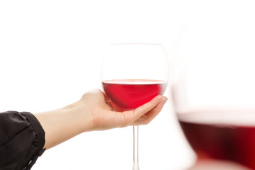 Glasses of red wine in two hands