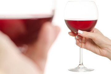 Glasses of red wine in two hands