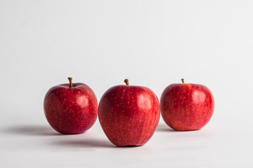 close-up view of fresh red apples on a white background
