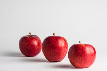 close-up view of fresh red apples on a white background