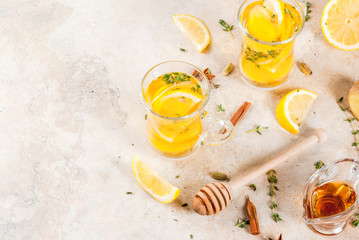 Fall and winter traditional drinks. Warming hot tea with lemon, ginger, spices (anise, cinnamon) and herbs (thyme), copy space