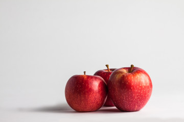 close-up view of fresh red apples on a white background