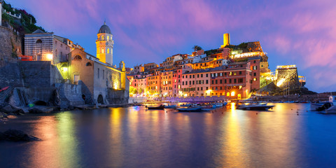 Panorama of night fishing village Vernazza with Santa Margherita di Antiochia Church and lookout...