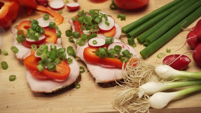 Table wooden board full of fresh food vegetables to make sandwich. Dolly sliding shot 4K ProRes HQ codec