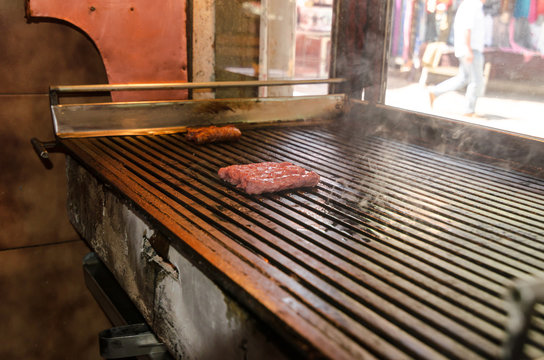 Traditional Balkans kebap or Cevapi,delicius minced meat grilled on a barbecue in old bazaar Skoje