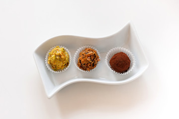 Luxury handmade chocolate candies plated on a white porcelain plate