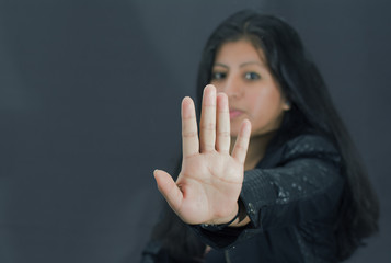 
Beautiful latin woman with hand stop