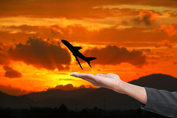 hand hold silhouette airplane  with sky sunset with copy space add text