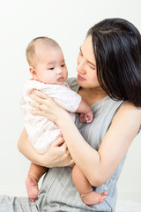 Portrait of happy asian mother hugging her cute baby