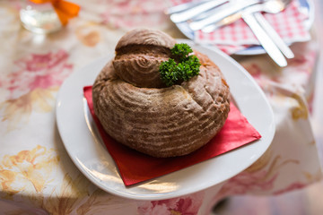 Meat soup in bread. A dish of Czech cuisine in the restaurant of Prague.