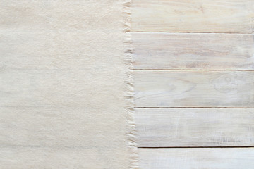Knitted material and grunge wood board texture background. Surface of aged white wooden planks and...