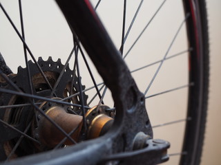 Part of the center of black iron structure bike wheel, with white background