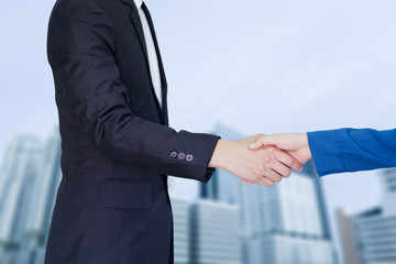 investor businessman in suit handshake together on modern building city background,executive...